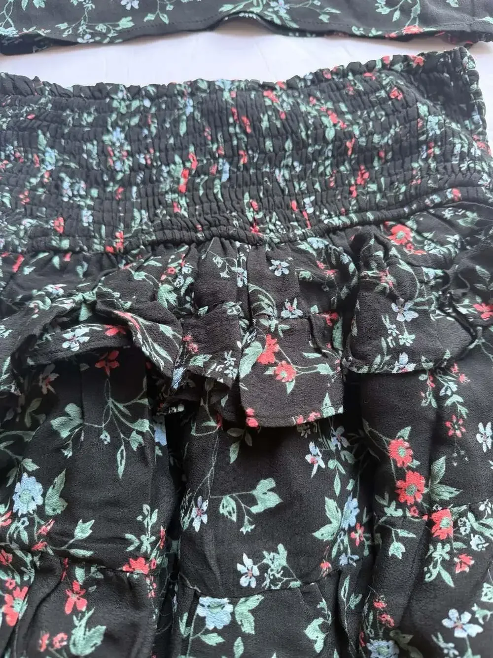 Olivaceous Black Floral Two-Piece Set with Smocked Ruffle Skirt and Crop Top